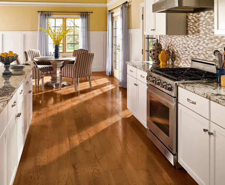 Kitchen area with seating in the back using Prime Harvest prefinished hardwood floors