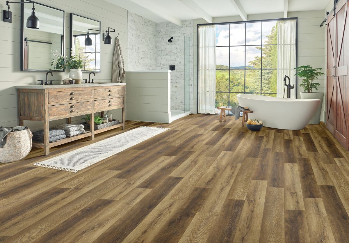 Bathroom with a claw foot tub, stand alone shower, and vanity using SPC flooring