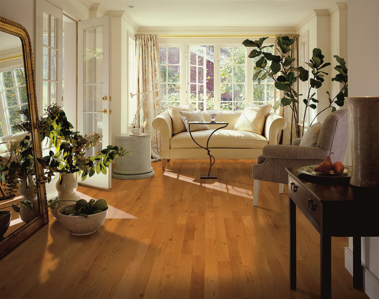 Living room area with doors to a patio and white oak flooring
